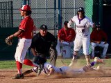 Lemoore's Gavin Kyker starts the celebration as Dominick Najar slides into home to win the game against Hanford.